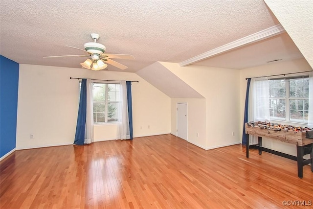 additional living space with baseboards, a ceiling fan, a textured ceiling, and wood finished floors