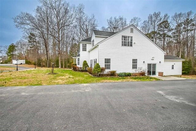 view of home's exterior with a yard