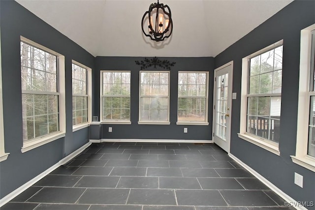 unfurnished sunroom with baseboards, vaulted ceiling, and tile patterned floors