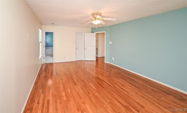 3090 Magnolia Woods Ct, Quinton, VA 23141 - unfurnished bedroom with baseboards, light wood-type flooring, and a textured ceiling