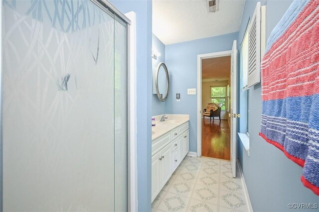 3090 Magnolia Woods Ct, Quinton, VA 23141 - full bath with vanity, a textured ceiling, baseboards, visible vents, and a stall shower