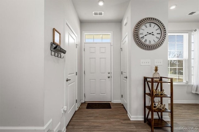 entryway with wood finished floors, visible vents, and a wealth of natural light