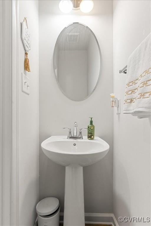 bathroom with baseboards and a sink