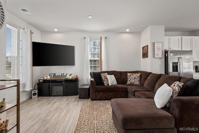 living area featuring recessed lighting and light wood finished floors