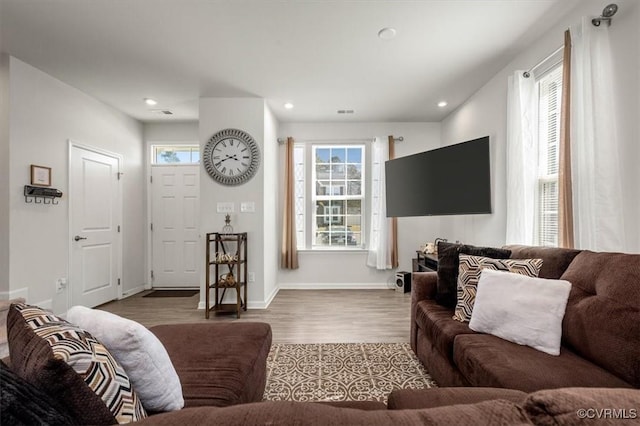 living room featuring plenty of natural light, wood finished floors, and recessed lighting