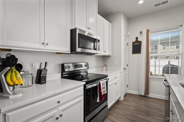 kitchen featuring visible vents, white cabinetry, appliances with stainless steel finishes, light countertops, and dark wood-style flooring