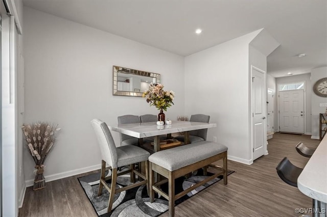 dining space featuring recessed lighting, baseboards, and wood finished floors