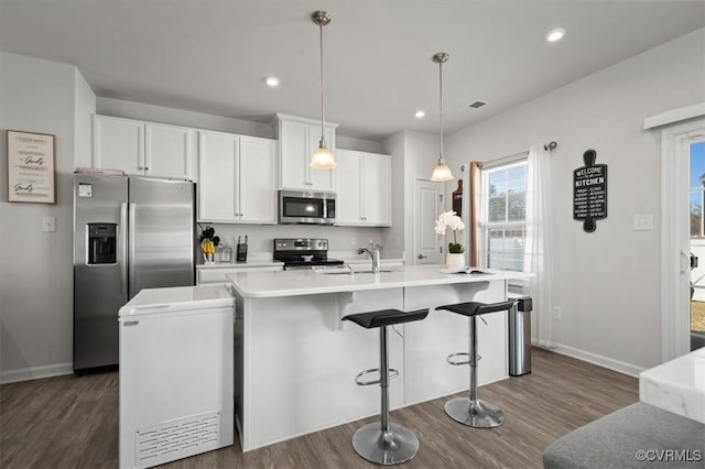 kitchen with recessed lighting, white cabinets, stainless steel appliances, and baseboards