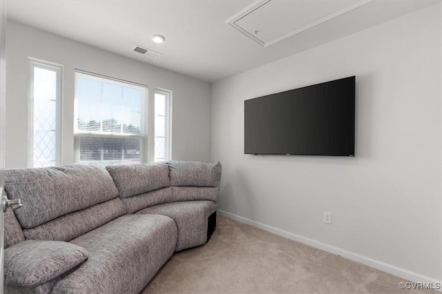 carpeted living room featuring attic access, baseboards, and visible vents