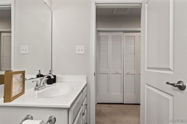 bathroom featuring visible vents, a closet, and vanity