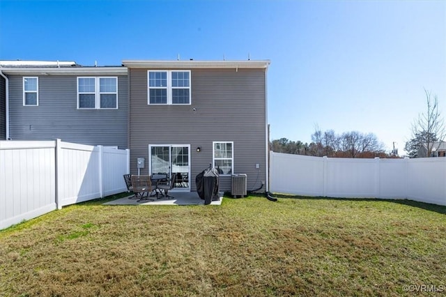 rear view of house featuring central air condition unit, a lawn, a fenced backyard, and a patio area