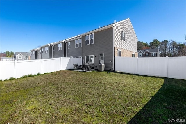 back of property featuring cooling unit, a lawn, a residential view, and a fenced backyard