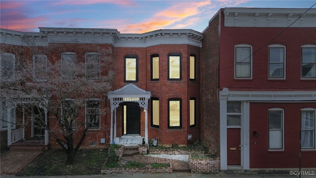 townhome / multi-family property with brick siding