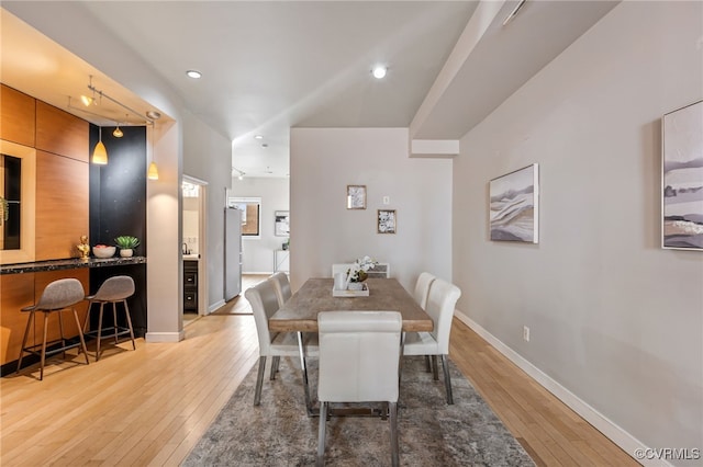 dining room with recessed lighting, light wood-type flooring, and baseboards