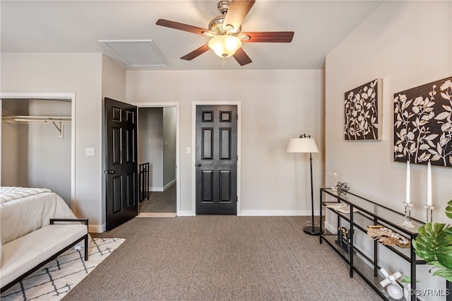 bedroom with a ceiling fan, baseboards, attic access, a closet, and carpet flooring