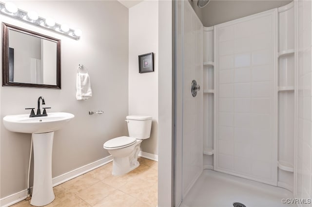 full bathroom featuring a shower, toilet, a sink, and tile patterned flooring