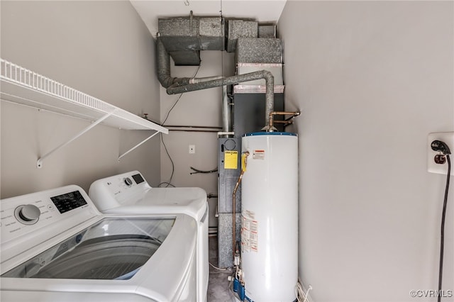 clothes washing area with laundry area, gas water heater, and separate washer and dryer