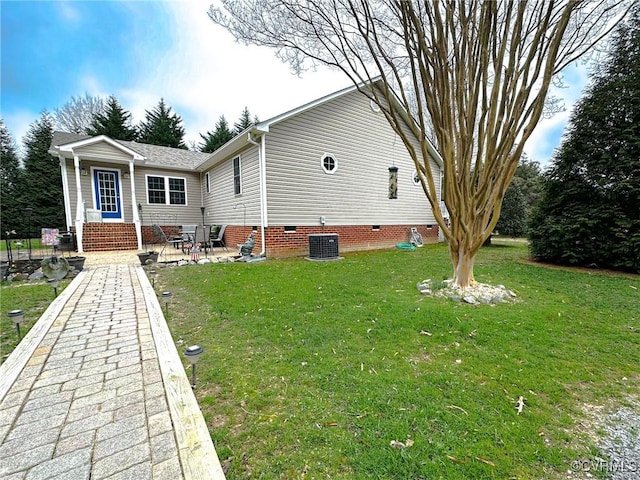 back of house featuring a yard and a patio area