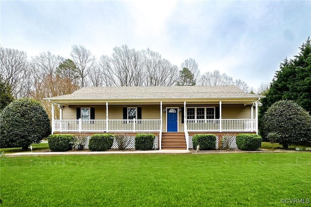 ranch-style house with roof with shingles, a porch, and a front yard