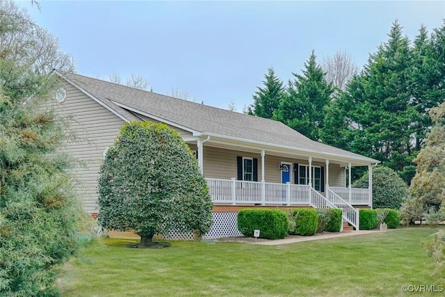 view of front of home with roof with shingles, covered porch, and a front yard