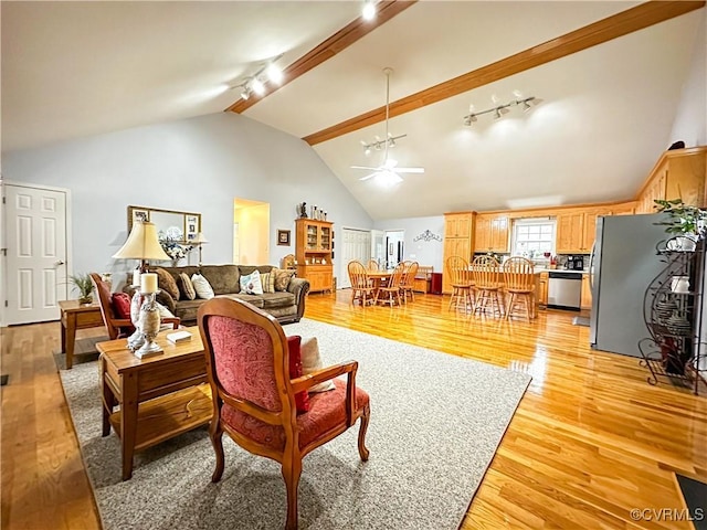 living room featuring light wood finished floors, rail lighting, high vaulted ceiling, and a ceiling fan