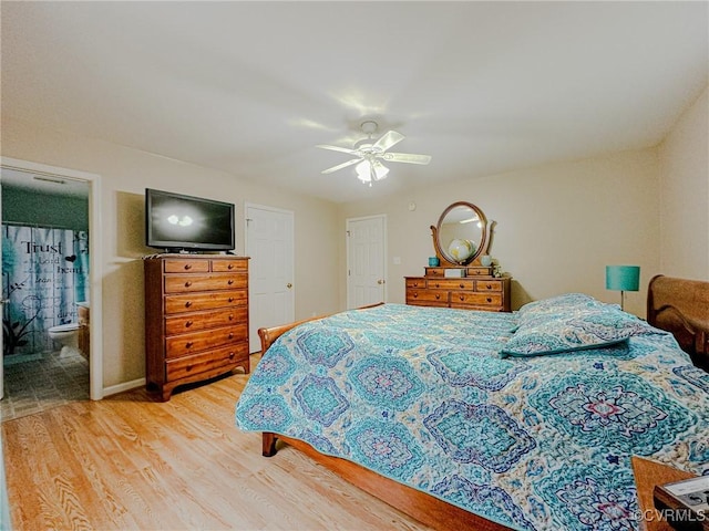 bedroom with connected bathroom, a ceiling fan, and light wood-style floors