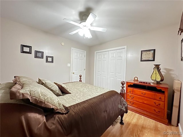 bedroom with a closet, light wood-style floors, and ceiling fan