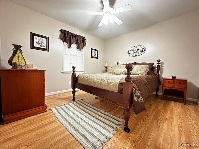 bedroom featuring light wood-style flooring, a ceiling fan, and baseboards