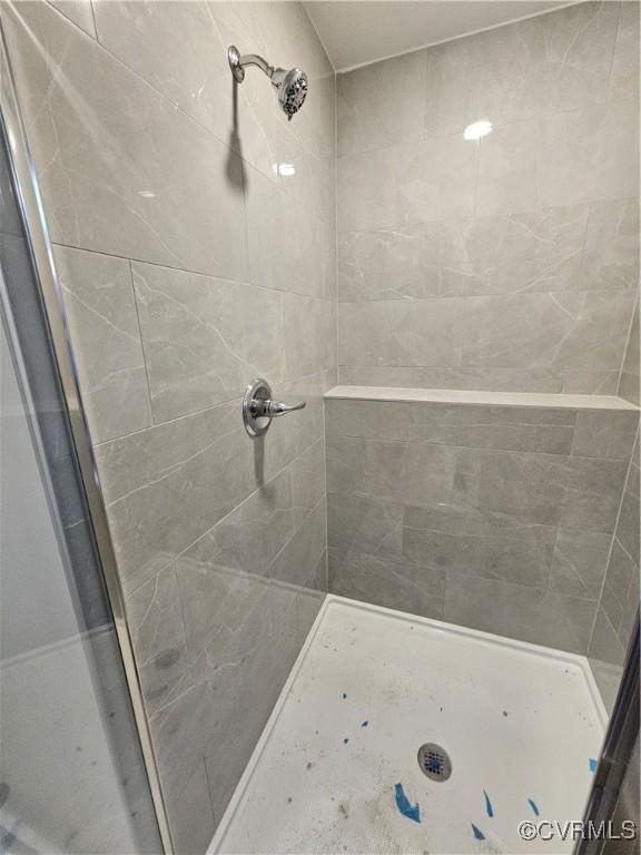 full bath with a shower stall