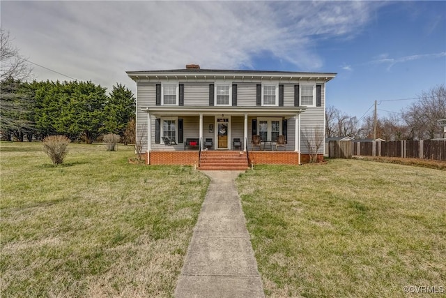 view of front of house with a chimney, a porch, a front lawn, and fence