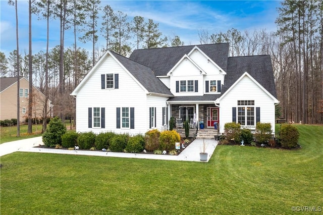 traditional-style house with a porch and a front lawn