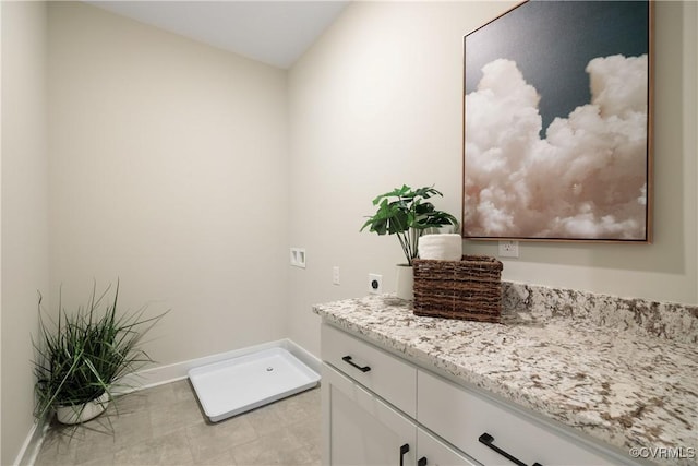 bathroom with vanity and baseboards