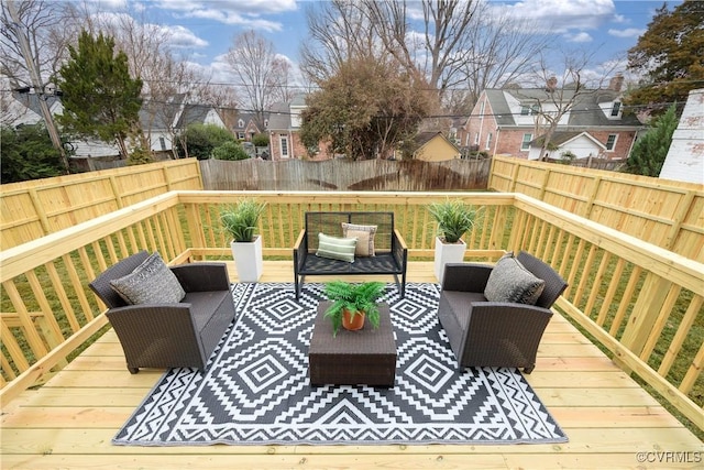 wooden deck featuring fence private yard, a residential view, and an outdoor hangout area