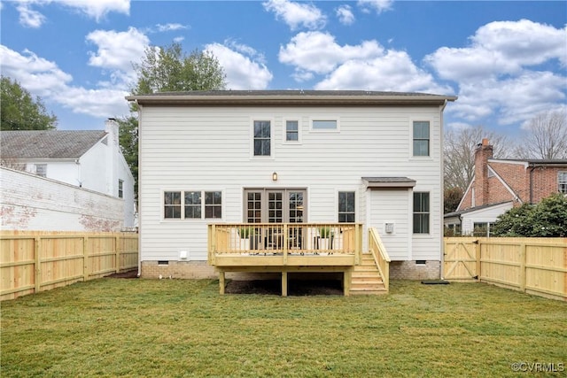 rear view of property with crawl space, a fenced backyard, a lawn, and a deck