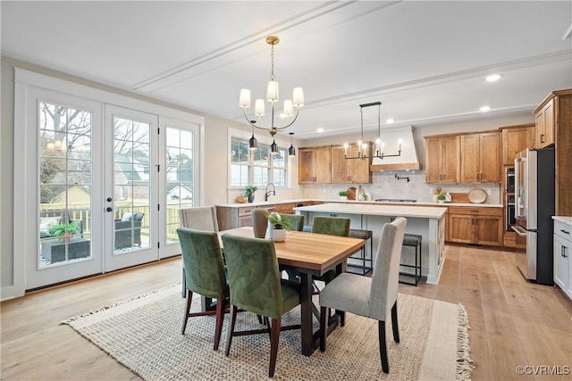 dining room featuring a notable chandelier, recessed lighting, and light wood-style floors