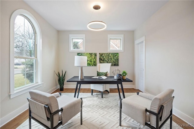 office featuring baseboards and light wood-style floors