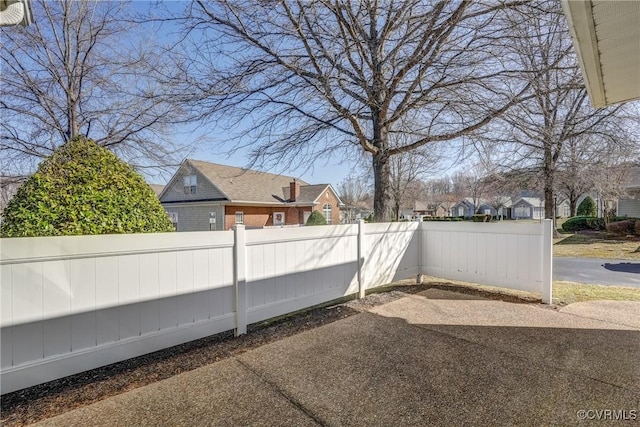 exterior space featuring fence and a residential view