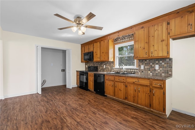 kitchen featuring brown cabinetry, black appliances, and a sink