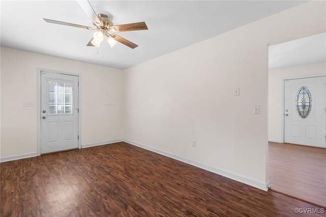 interior space featuring a ceiling fan, wood finished floors, and baseboards