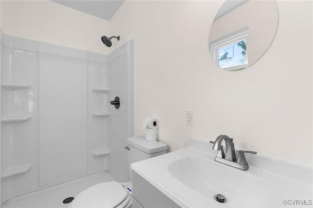 bathroom with toilet, walk in shower, and vanity