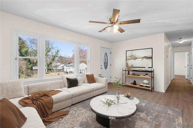 living area featuring ceiling fan and wood finished floors