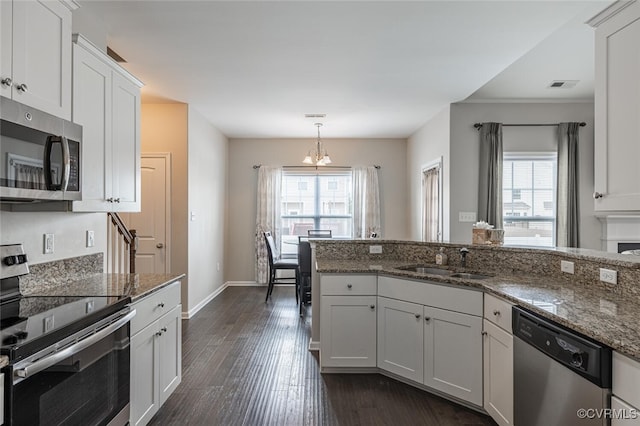 kitchen with a healthy amount of sunlight, visible vents, dark wood finished floors, a sink, and appliances with stainless steel finishes