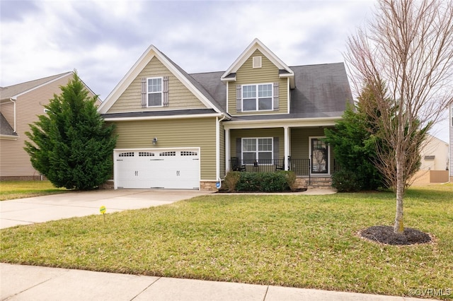 craftsman-style home with covered porch, driveway, and a front lawn