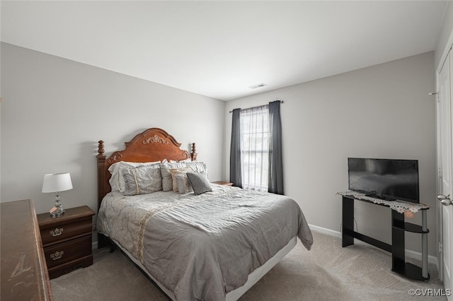 bedroom featuring visible vents, light carpet, and baseboards