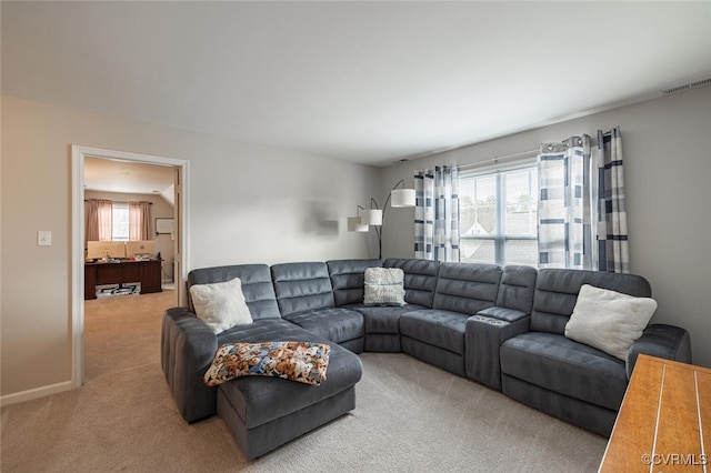 living room with light carpet, visible vents, and baseboards