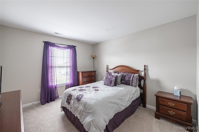 bedroom featuring visible vents, baseboards, and light colored carpet