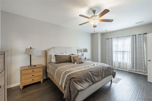 bedroom featuring ceiling fan, visible vents, baseboards, and dark wood-style floors