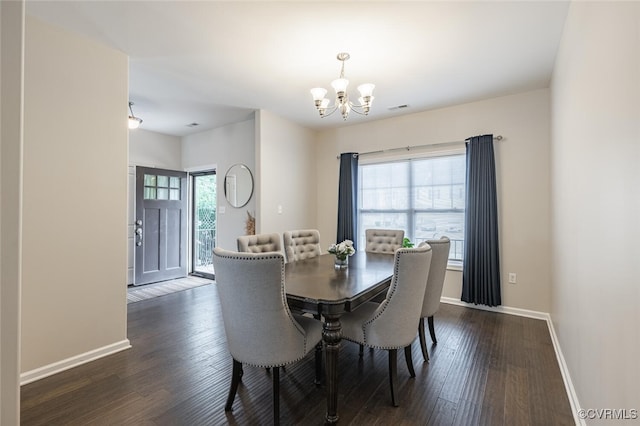 dining room featuring an inviting chandelier, baseboards, dark wood-type flooring, and visible vents