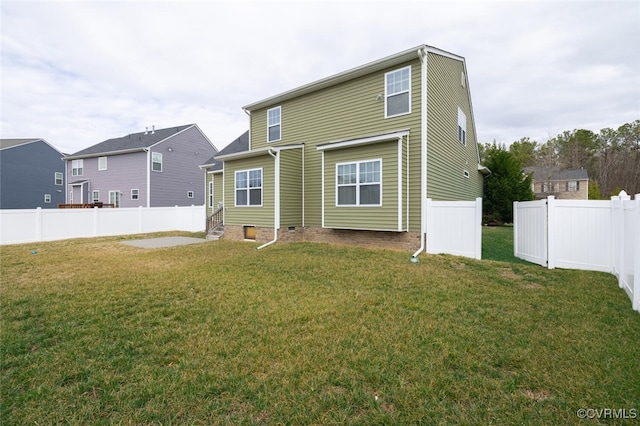 back of property with crawl space, a lawn, and a fenced backyard