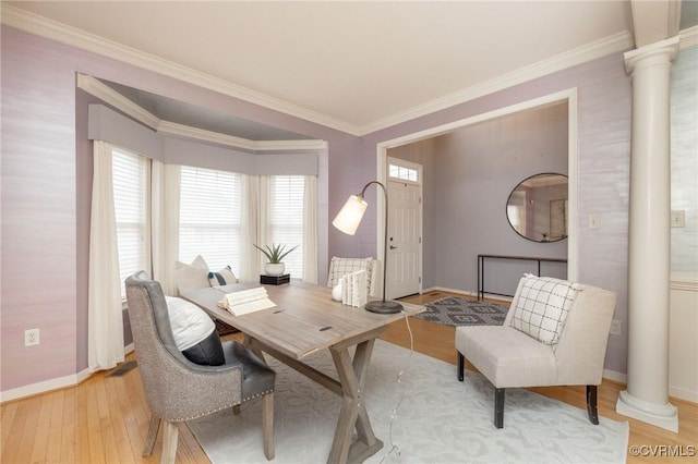 office area with baseboards, visible vents, decorative columns, light wood-style floors, and crown molding